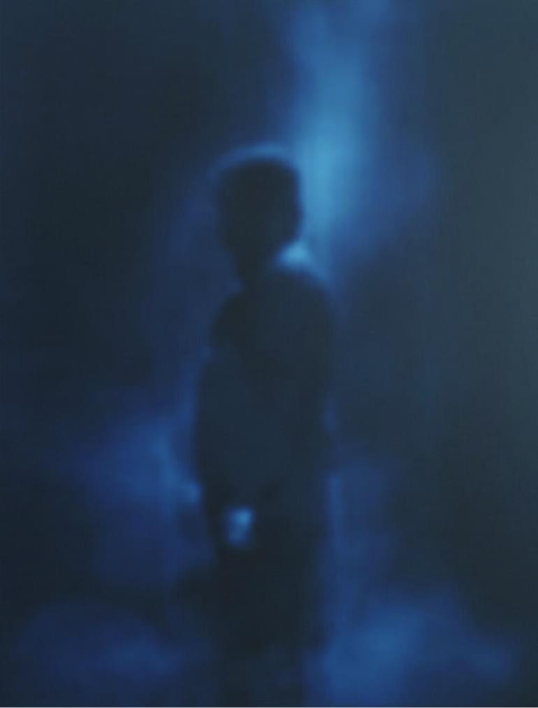 a shadowed figure with a dark background. The figure wears a hood and is in profile. Cover image for Mortevivum: Photography and the Politics of the Visual.